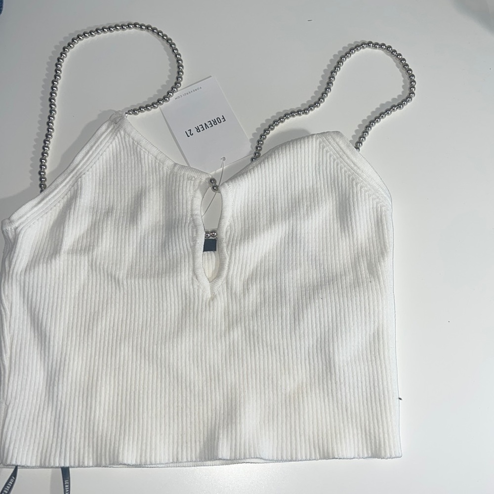 White knitted v neck opening crop top with beaded straps.